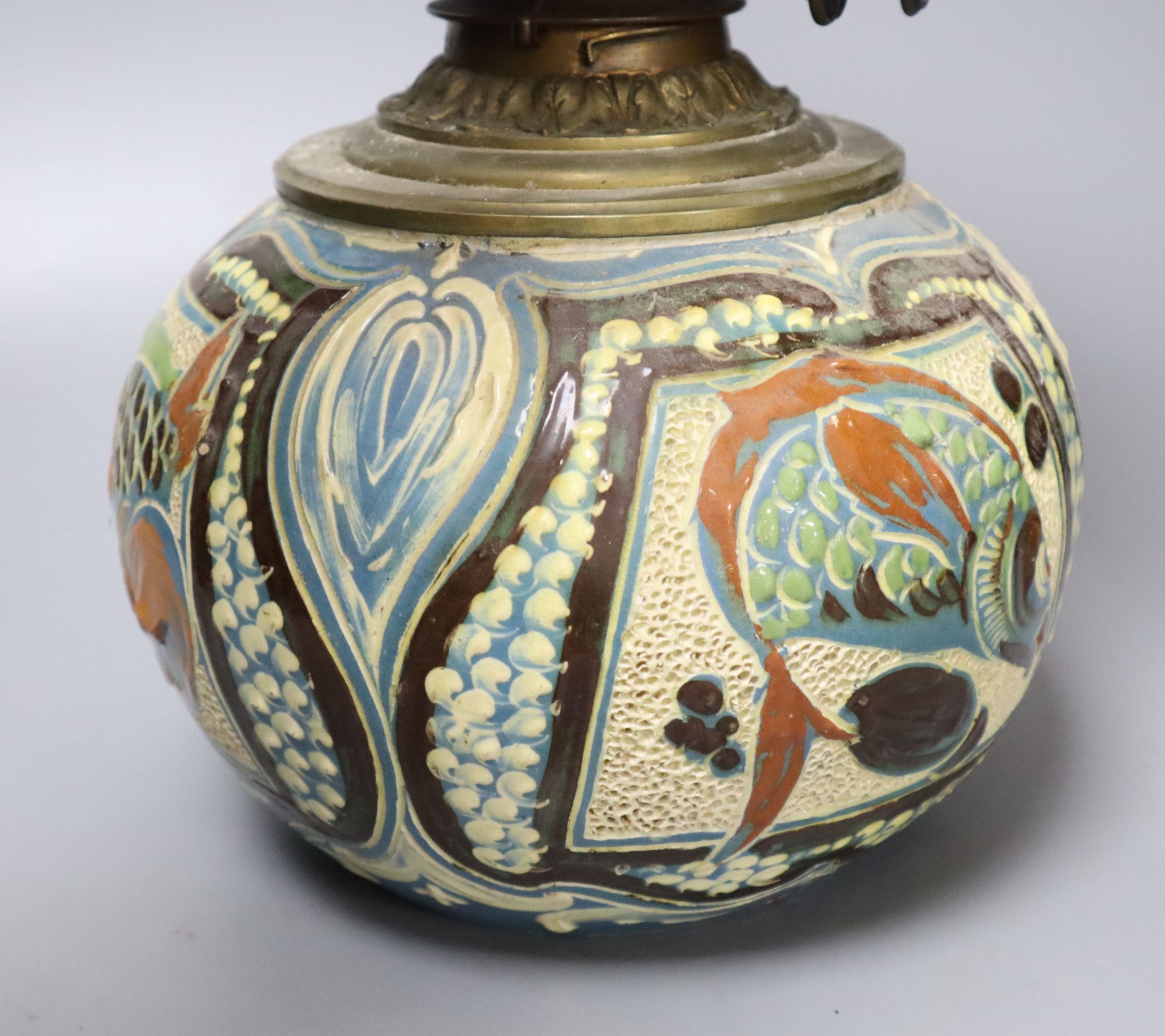 A C. H. Brannam Barum pottery oil lamp, decorated with fish, signed and dated 1899, height 50cm including chimney